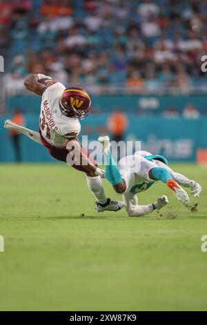 Miami Gardens, FL USA;  Washington Commanders running back Jeremy McNichols (31) runs with the ball and tackled by Miami Dolphins cornerback Cam Smith Stock Photo