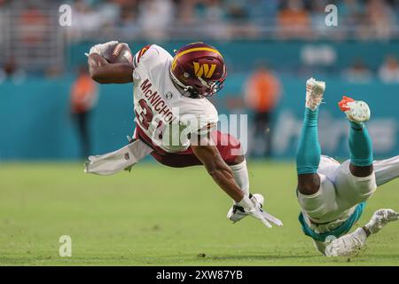 Miami Gardens, FL USA;  Washington Commanders running back Jeremy McNichols (31) runs with the ball and tackled by Miami Dolphins cornerback Cam Smith Stock Photo