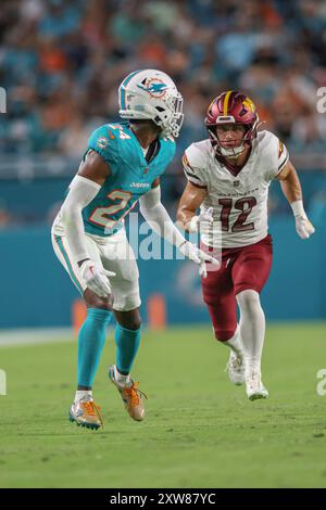 Miami Gardens, FL USA;  Washington Commanders wide receiver Luke McCaffrey (12) runs up the field while covered by Miami Dolphins cornerback Cam Smith Stock Photo