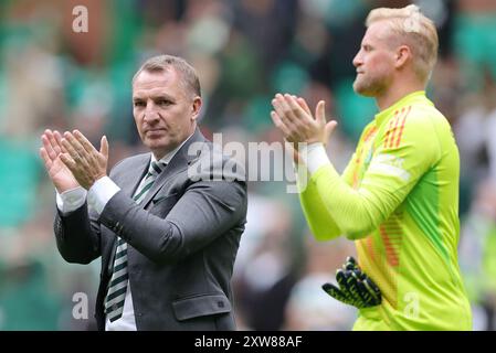 Celtic goalkeeper Kasper Schmeichel and manager Brendan Rodgers applauds the fans after the Premier Sports Cup match at Celtic Park, Glasgow. Picture date: Sunday August 18, 2024. Stock Photo