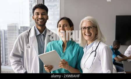 Three multiracial internists team mates looking at camera Stock Photo