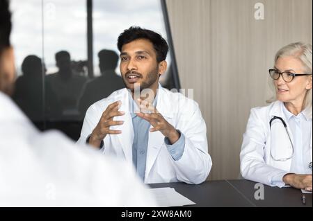 Indian male doctor speaking, sharing insights, presenting information during seminar Stock Photo
