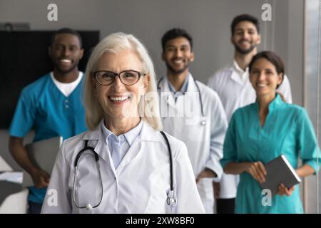 Group of diverse doctors standing together in clinic office Stock Photo