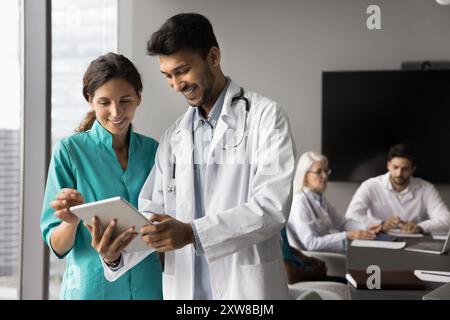 Two doctors standing together and looking at tablet Stock Photo