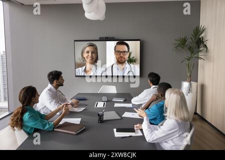 Mature patient displayed on screen during medical council with internists Stock Photo