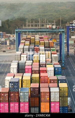 Puerto Quetzal, Guatemala - 19 January 2024: Cranes and shipping containers in the container terminal of the country's main sea port. Stock Photo