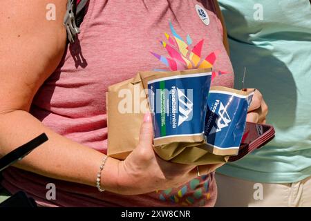 Puerto Quetzal, Guatemala - 19 January 2024: Tourist holding bags of Columbian coffee bought in Guatemala. Stock Photo