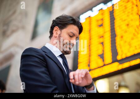 Commuter checking time in front of a timetable Stock Photo