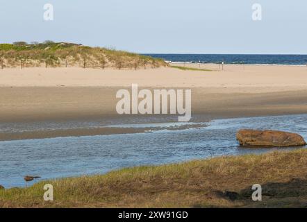 Small clean public beach close to Rockport. Parking lot gets filled in the summer. Sand dunes here are a common site. Small island here, walk to it in Stock Photo