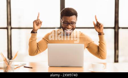 Ecstatic afro guy found new good idea Stock Photo