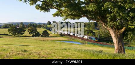 First Trenitalia Avant West Coast Alstom Pendolino train 390156  on the west coast mainline in Lancashire Stock Photo
