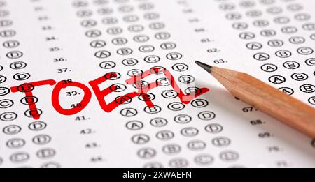 Close up view of an exam paper with the word TOEFL test of English as a Foreign Language and a pencil. Education, exam, quiz and school success concep Stock Photo