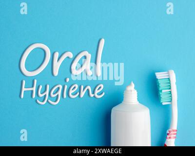 The word Oral Hygiene written with toothpaste on blue background. Dental care concept. Stock Photo