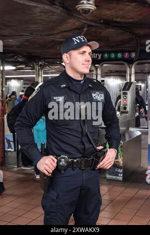 Policeman on guard Caucasian male Police Man on guard inside a down town Manhattan Subway Station, just after the Brussels terror attacks. New York City, New York, USA. New York City Union Square Subway Station, dow New York United States of America Copyright: xGuidoxKoppesxPhotox Stock Photo