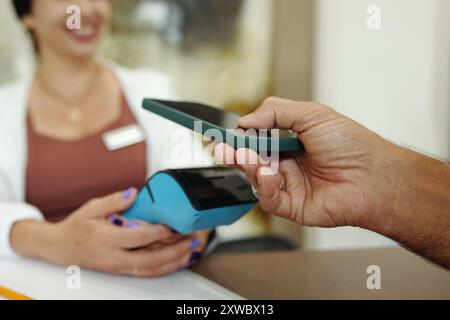 Client Paying With Mobile Phone For Sport Gym Stock Photo