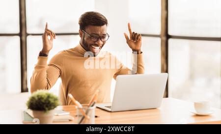 Ecstatic afro guy found new good idea Stock Photo