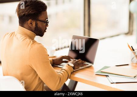 Focused black guy checking email on computer Stock Photo