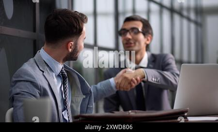 Modern office. Portrait of stylish businessmen working on laptop, analyzing data and creative designer. Stock Photo