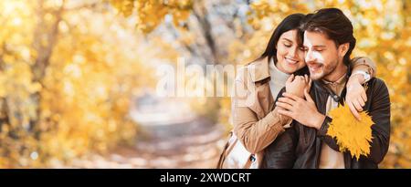 Loving woman hugging her handsome husband from behind Stock Photo