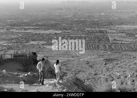 A young Caucasian couple checking out the view at Dobbins Lookout in South Mountain Park, Phoenix, Arizona. USA. Stock Photo