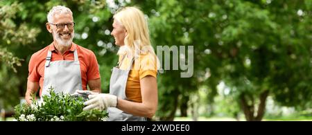 Beautiful Mature Spouses Having Fun While Gardening Together Outdoors Stock Photo