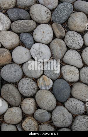 Rounded stones in Sicilian garden, Italy Stock Photo