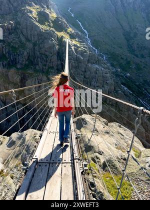 Woman Crossing Rope Young woman crossing the chasm on the rope bridge Stock Photo - Alamy