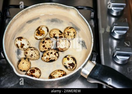 Boiling quail eggs Stock Photo