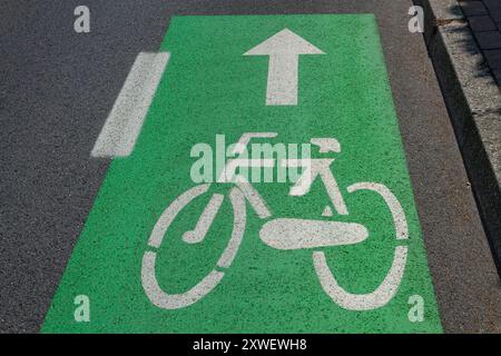 Green bicycle lane sign on asphalt Stock Photo