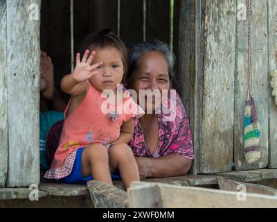 Santa Rita, Peru - Sep 2017: Portrait of a child and grandmother a local inhabitant of the Amazon rainforest - in the Javari Valley. Amazonas. Latin A Stock Photo