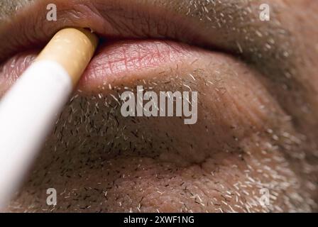 Man with cigarette in mouth Stock Photo