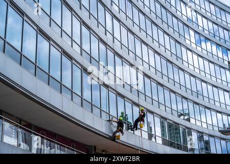 Just hanging around abseil cleaning windows in Piccadilly Manchester UK Stock Photo