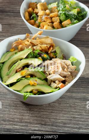 A view of a Southwestern chicken salad, and a Caesar salad. Stock Photo