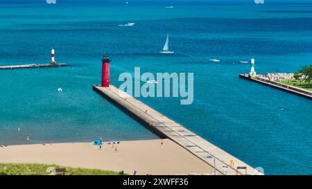 Aerial Fly Over Three Lighthouses and Sandy Beach on Lake Michigan Stock Photo