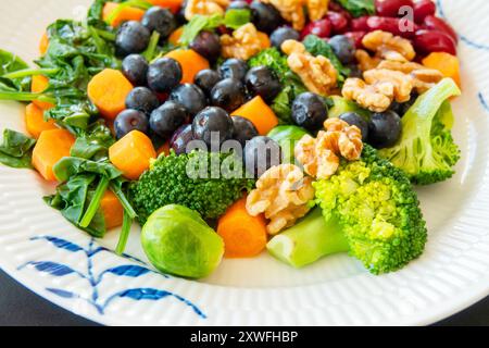 Close-up of healthy colorful diet food a tasty porton steamed and roasted vegetables broccoli, spinach, carrots, red beans and Brussels sprouts topped Stock Photo