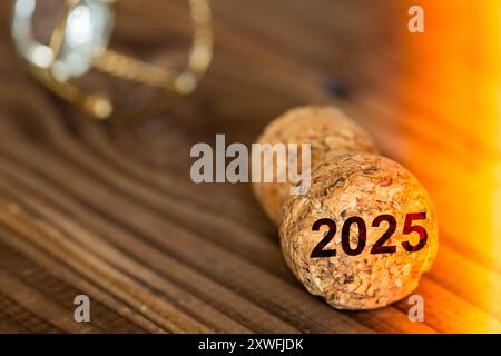 Year 2025. A popped champagne cork with the date 2025. Celebrating the new year, close up Stock Photo