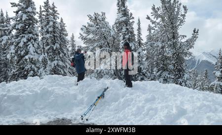 Tourists on viewing gallery at Sulphur Mountain at the top of the Sulphur Mountain Gondola in winter Banff Alberta Canada Stock Photo