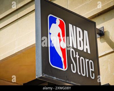 08 19 2024 - Paris, France. NBA store sign with league logo on an old building in Paris city where is located official fans apparel, merchandise shop Stock Photo