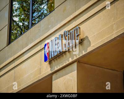 08 19 2024 - Paris, France. NBA store sign with league logo on an old building in Paris city where is located official fans apparel, merchandise shop Stock Photo