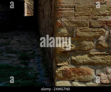 Alley Street Passage: Old Stone Wall Leading to Light at the End of the Tunnel – Around the Corner. Stock Photo