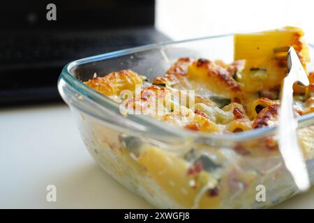 Lunch with pasta in Tupperware at the office desk Stock Photo