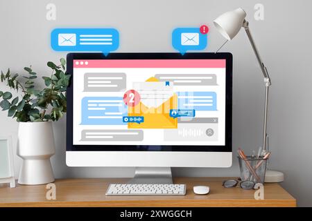 Received email messages on screen of computer monitor at workplace Stock Photo