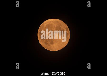 Blue full supermoon above Belgium glows red because of North American wildfire smoke in the atmosphere on August 19 2024 Stock Photo
