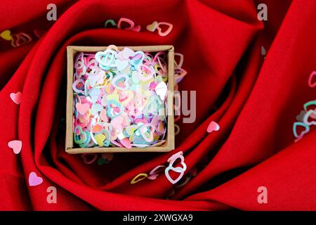 Cardboard box full of colorful hearts Stock Photo