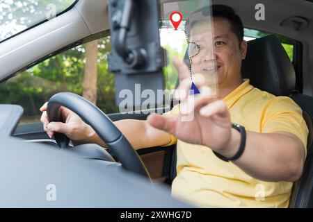 Close-up on a couple using the GPS while driving a car. Driver using GPS navigation in mobile phone while driving car at sunset. Man using mobile phon Stock Photo