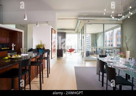 View of modern condominium showing kitchen, dining, living room, terrace Stock Photo