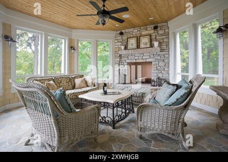 Three season porch with stone fireplace and floor Stock Photo