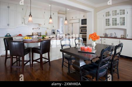 White kitchen with arched details of cabinets Stock Photo