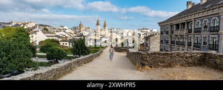 Great panoramic view of the city of Lugo from the top of the Roman wall that surrounds the city, where people walk sightseeing Stock Photo