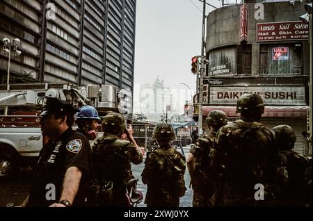 Military, NYPD and NYFD stand guard on Broadway. What's left of the towers still standing in the distance. On September 11, 2001, four commercial US airplanes were hijacked by Al-Qaeda, an Islamist extremist terrorist group, and were weaponized against the United States. Killing nearly 3000 people and injuring 6000 more it was the worst attack to happen on United States soil. Two of the planes were flown into new York's World Trade Center, destroying the Twin Towers and killing 2,977 people. These are photos from that day and the week to follow and shot on film (Photo by Syndi Pilar/SOPA Ima Stock Photo